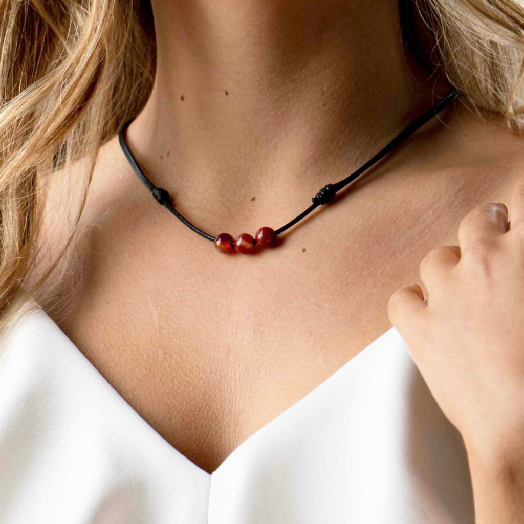 Man confidently sporting a Carnelian Beaded Choker, highlighting the bold and empowering energy of the accessory with his trendy look - Luck Strings