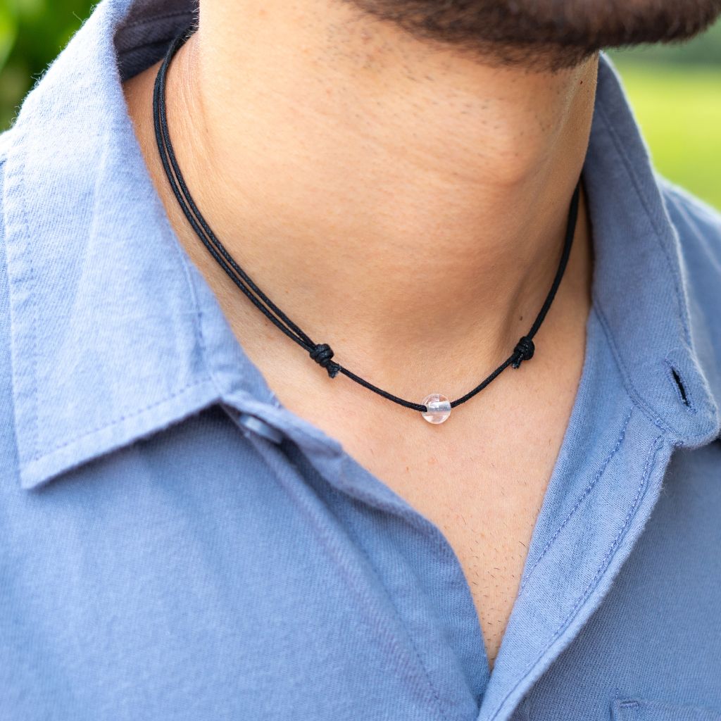 Man wearing a Luck Strings Unisex Beaded Choker, showcasing a variety of gemstones on an adjustable cord, reflecting a blend of style and diverse energies.