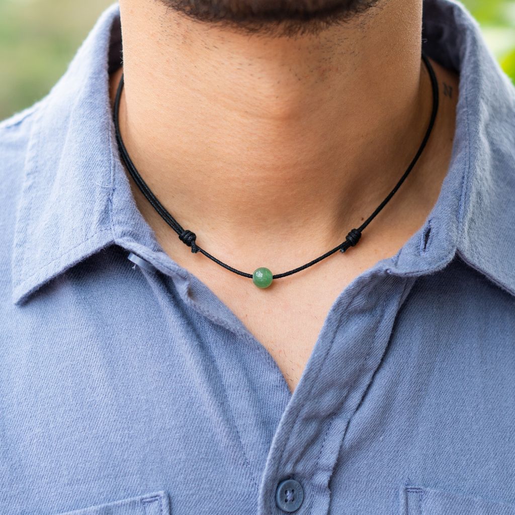 Man wearing a Luck Strings Unisex Beaded Choker, showcasing a variety of gemstones on an adjustable cord, reflecting a blend of style and diverse energies.