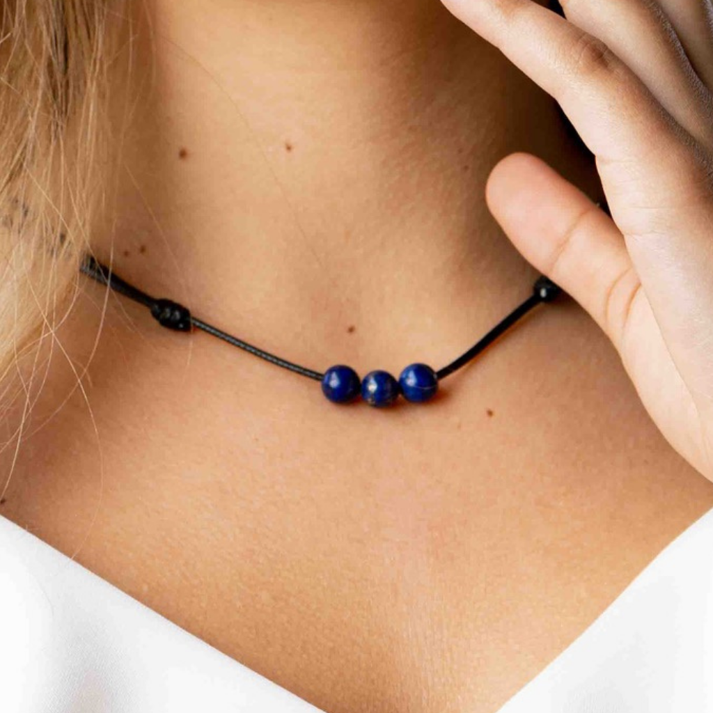 Woman showcasing an elegant Lapis Lazuli Beaded Choker, with deep blue beads complementing her sophisticated outfit - LUCK STRINGS
