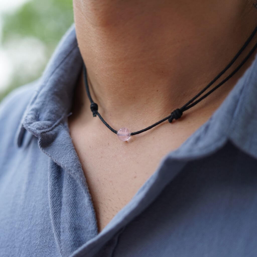 Man wearing a Luck Strings Unisex Beaded Choker, showcasing a variety of gemstones on an adjustable cord, reflecting a blend of style and diverse energies.