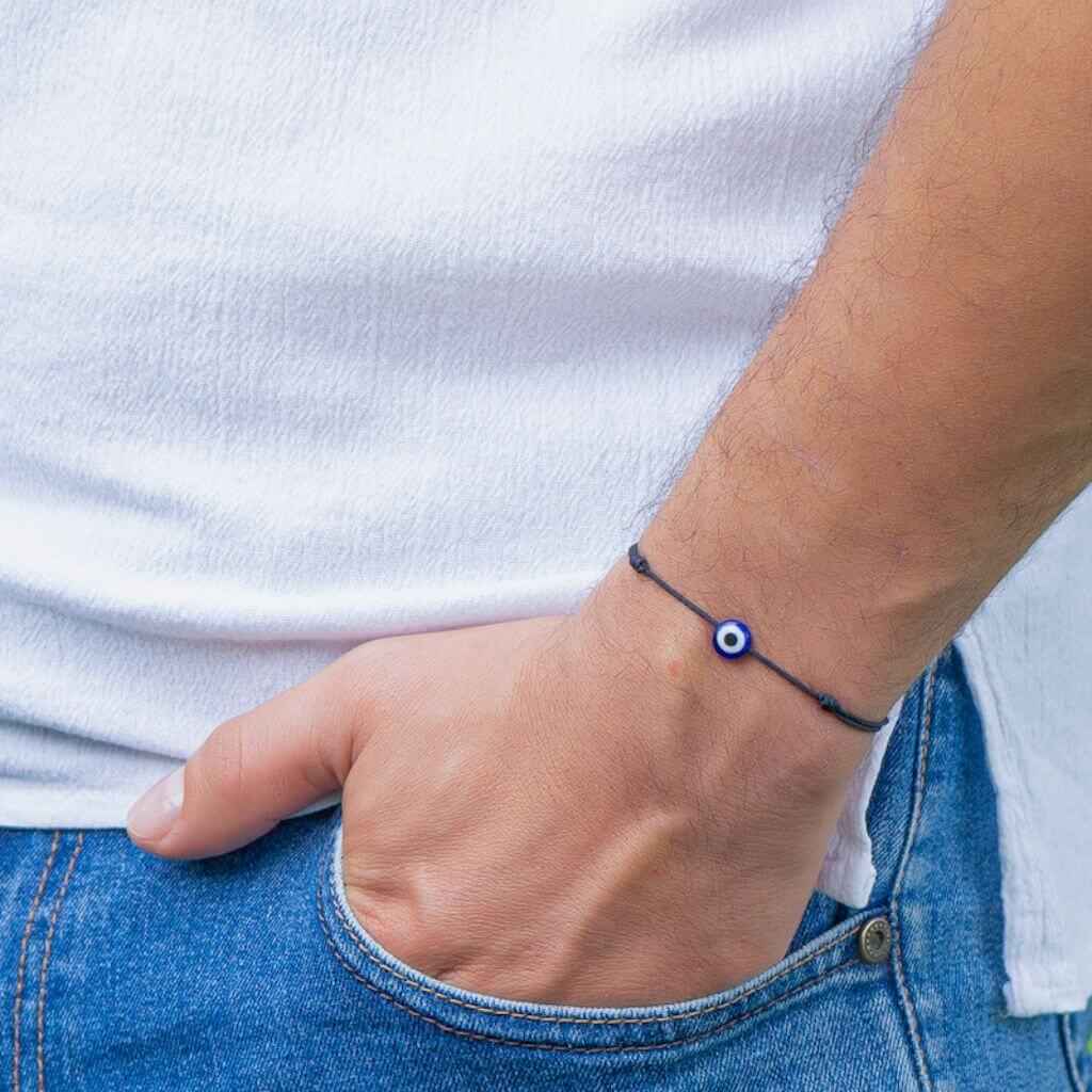 Man wearing a minimalist red cord evil eye bracelet, showcasing a subtle yet stylish protective accessory. - Luck Strings