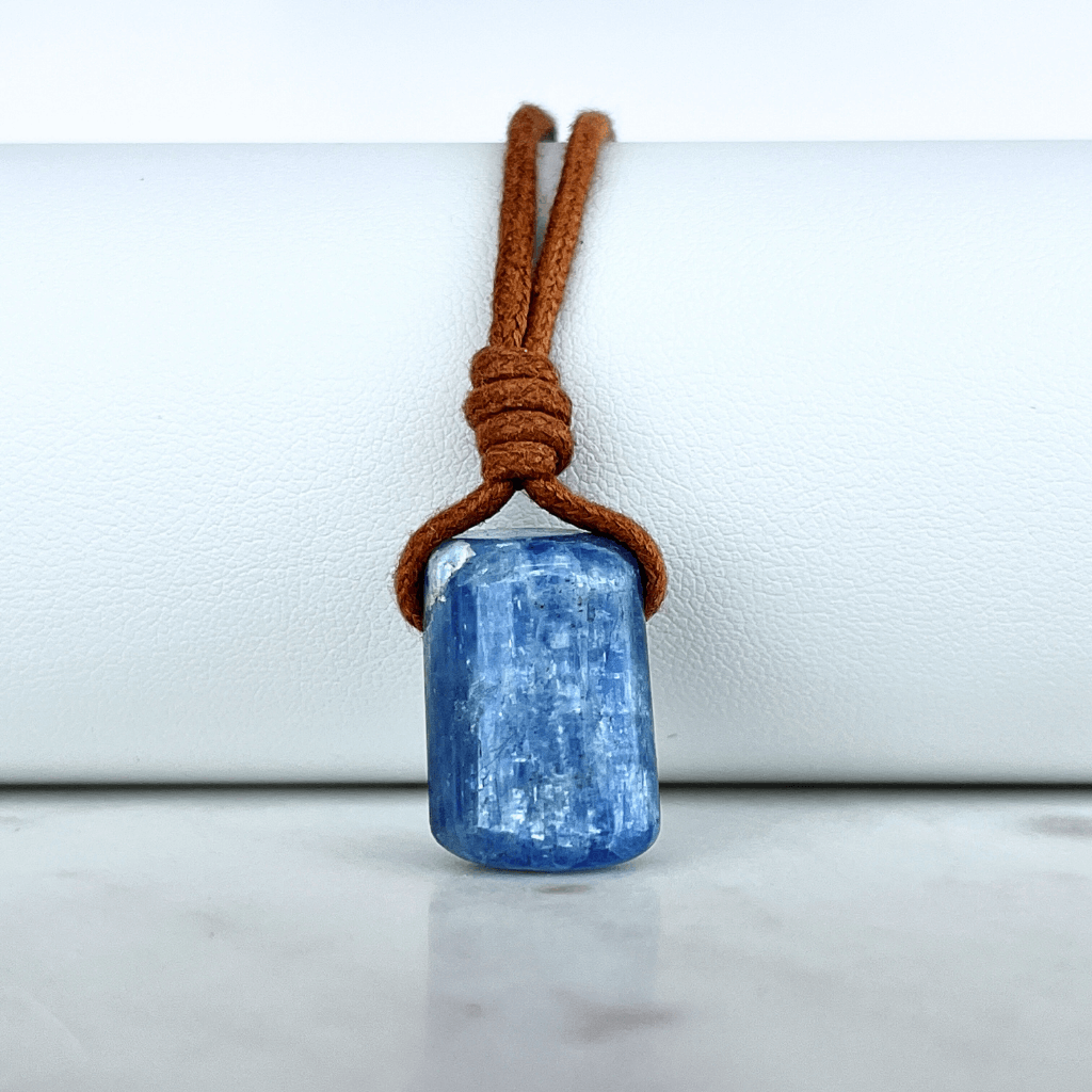 A unique handcrafted Kyanite pendant showcasing tranquil blue shades, embodying beauty and serenity.