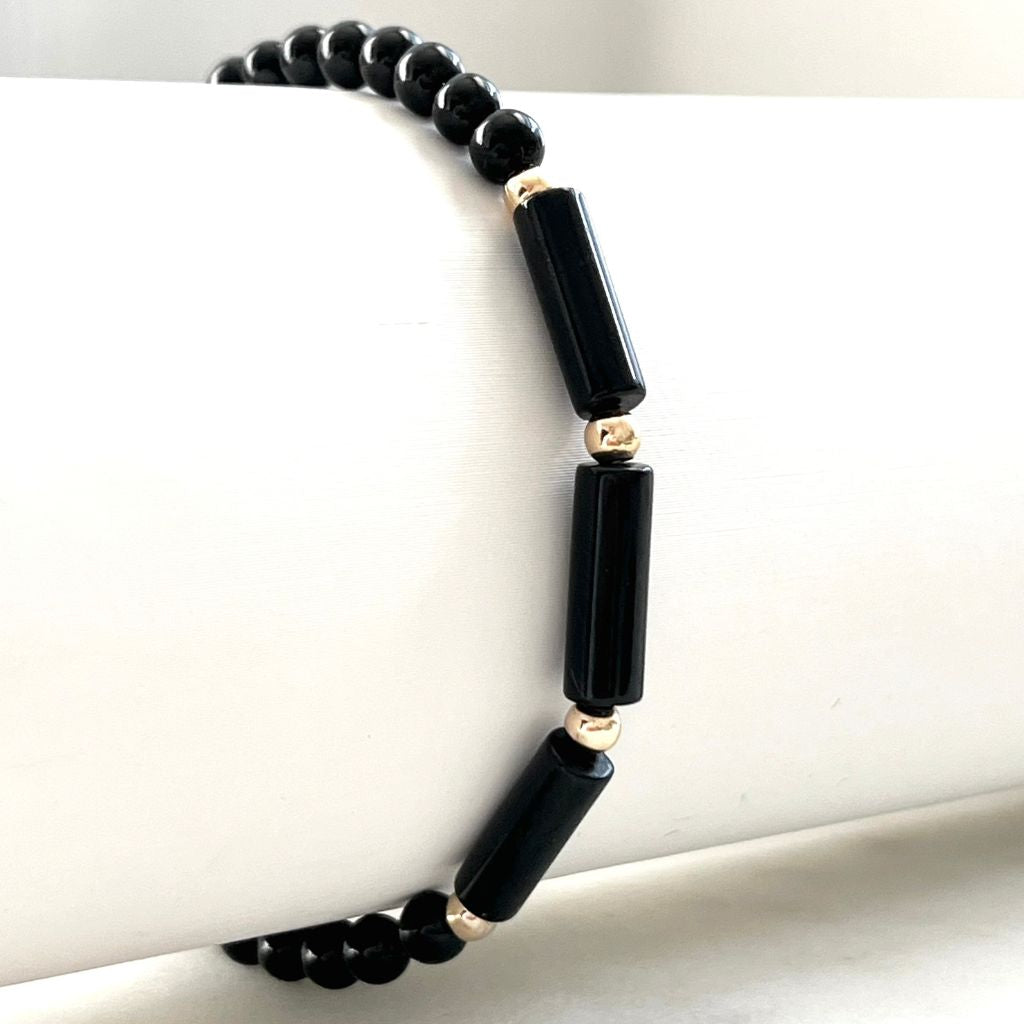 Black Tourmaline 14K Gold Bracelet, highlighting the sleek black gemstone beads complemented by gleaming gold accents - by Luck Strings.