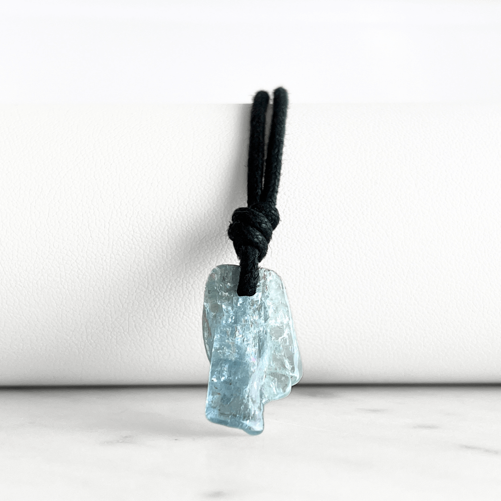 Tranquil Harmony: A pendant necklace adorned with a natural small aquamarine gemstone, representing the peaceful balance of tranquility and serenity.