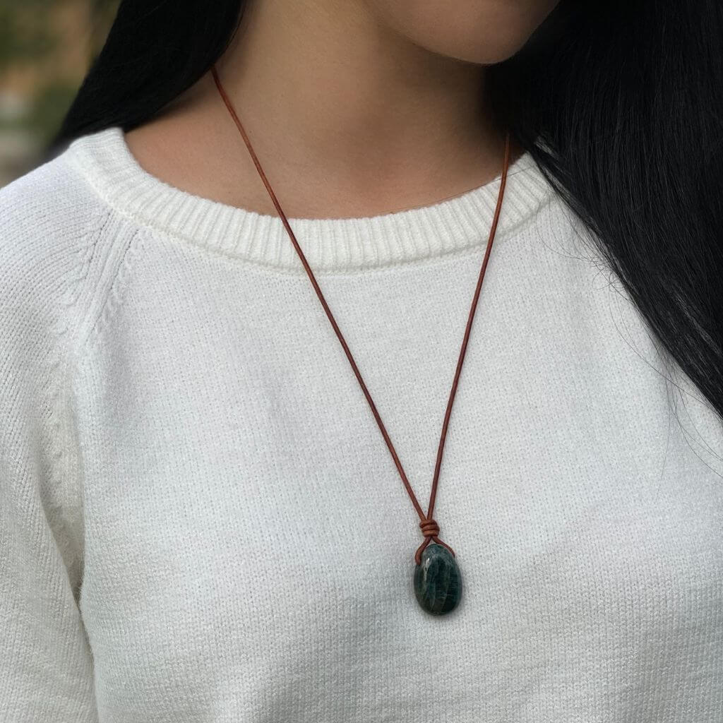 Luck Strings elegant and versatile apatite necklace, adjustable for different styles, displayed on a white sweater.