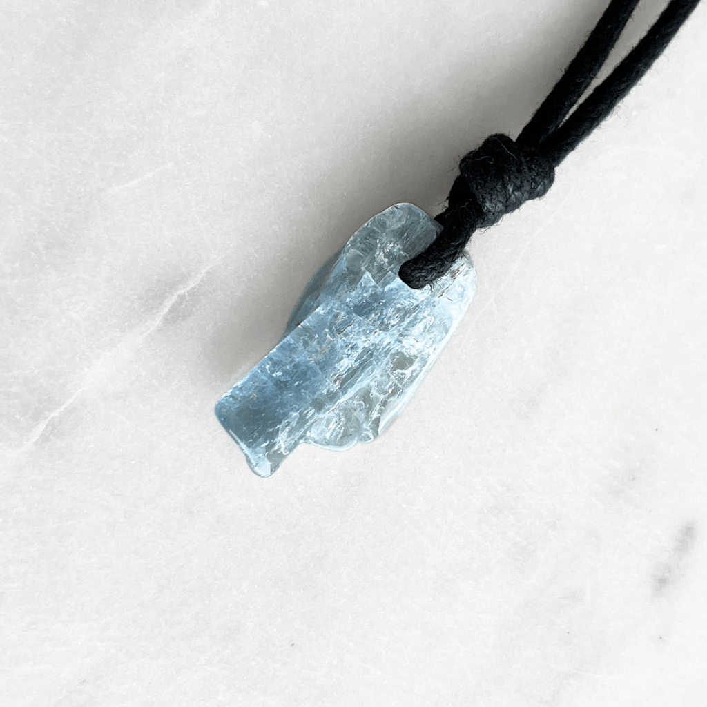 Tranquil Harmony: A pendant necklace adorned with a natural small aquamarine gemstone, representing the peaceful balance of tranquility and serenity.