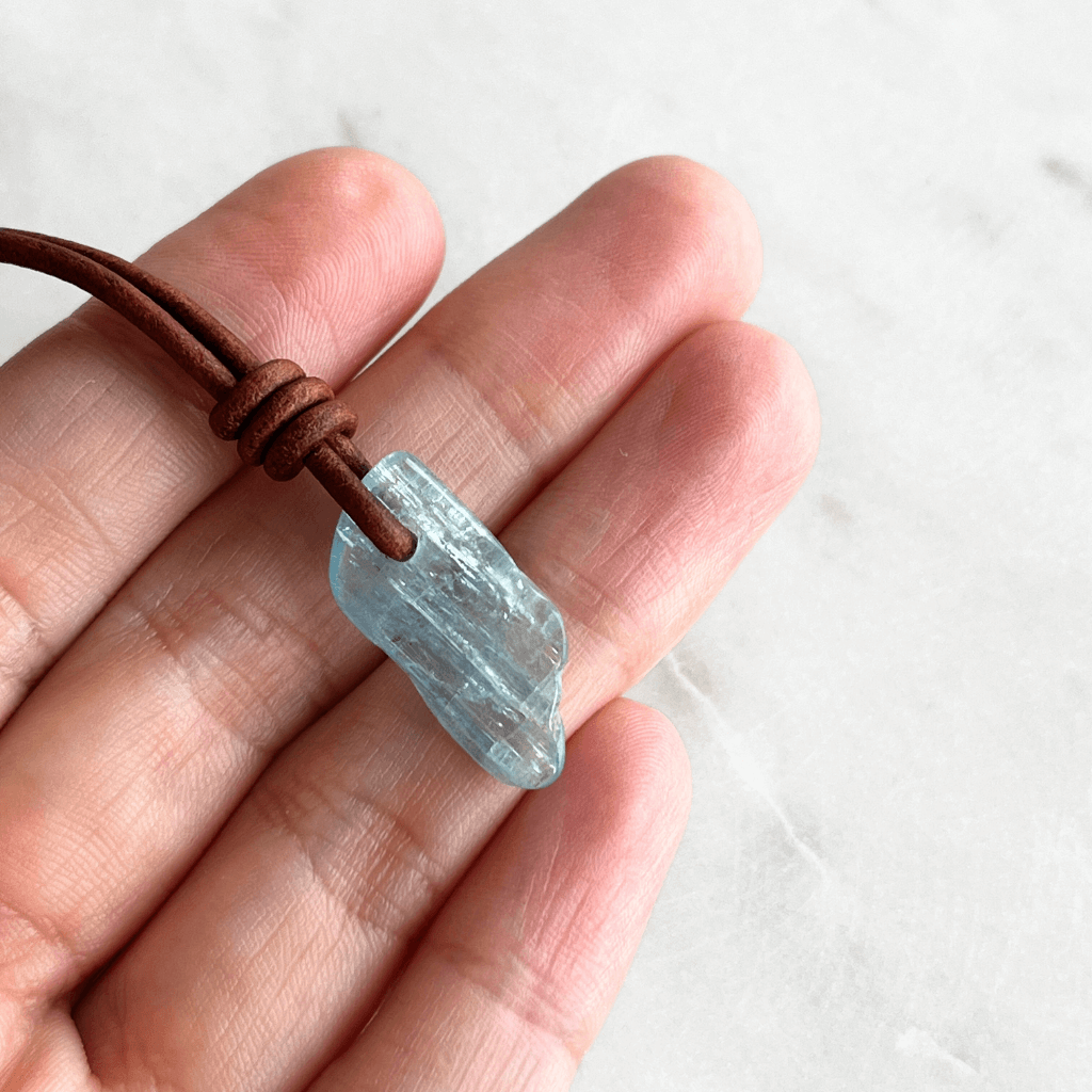 Serene Reflections: A pendant necklace showcasing a natural small aquamarine gemstone, echoing the calm and peaceful reflections of a tranquil surface.