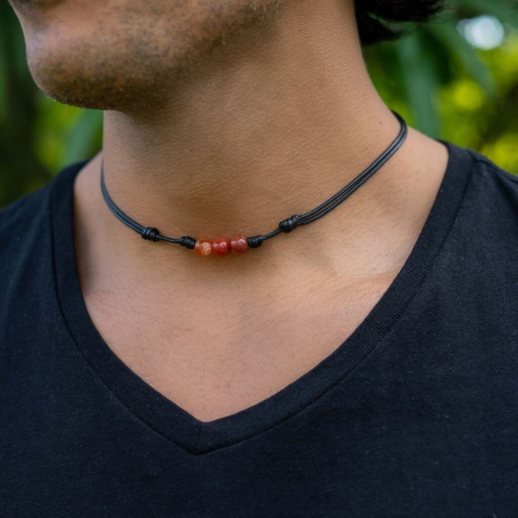 Man confidently sporting a Carnelian Beaded Choker, highlighting the bold and empowering energy of the accessory with his trendy look - Luck Strings
