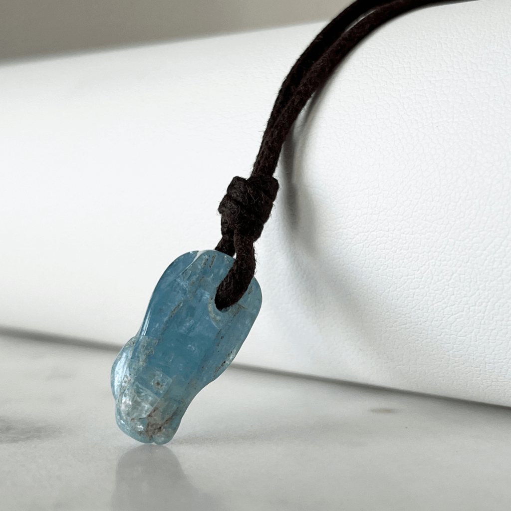 Unique Raw Aquamarine Stick Pendant, showcasing its elongated, natural form and serene blue hues, symbolizing tranquility and clarity - Luck Strings.