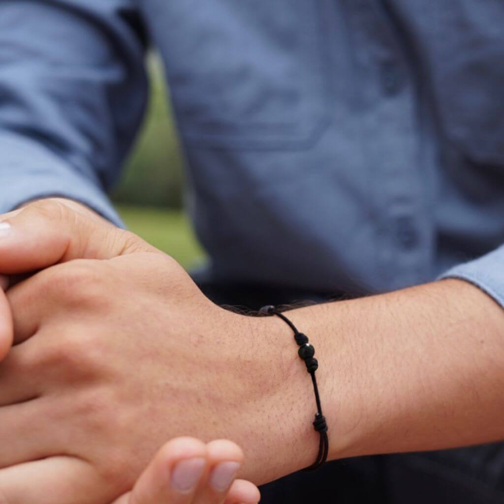 Man wearing the Luck Strings Energy Shield Black Tourmaline Bracelet, combining strength with elegance.