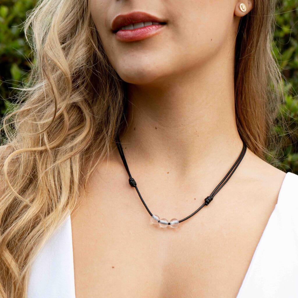 Woman gracefully wearing a Clear Quartz Beaded Choker, highlighting its luminous beads and adding a touch of refined elegance to her look - Luck Strings
