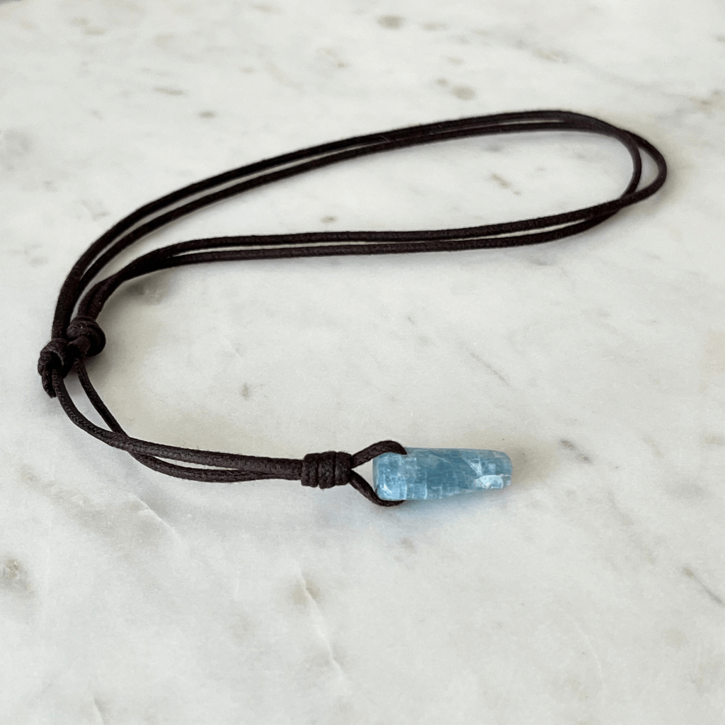 Unique Raw Aquamarine Stick Pendant, showcasing its elongated, natural form and serene blue hues, symbolizing tranquility and clarity - Luck Strings.