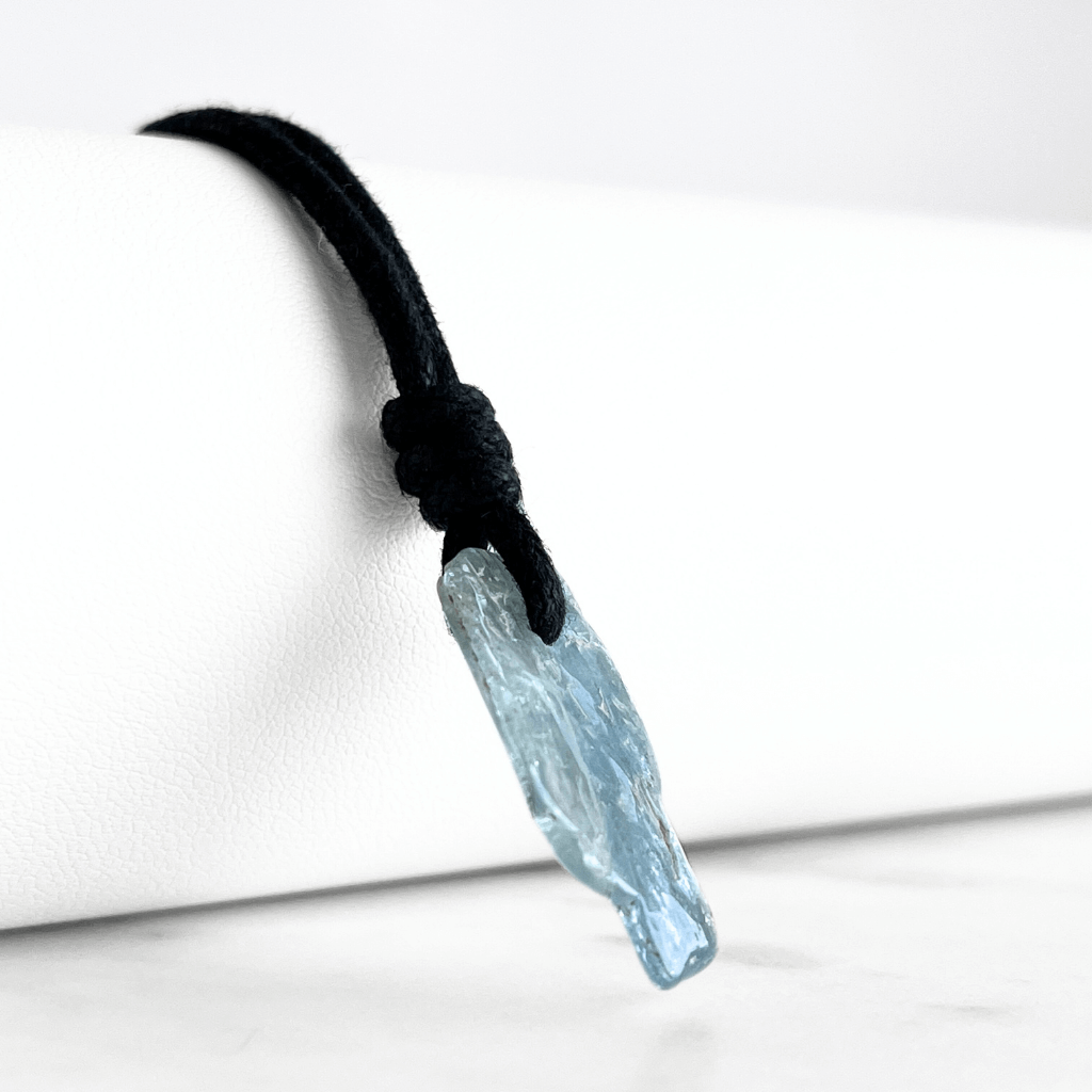 Tranquil Harmony: A pendant necklace adorned with a natural small aquamarine gemstone, representing the peaceful balance of tranquility and serenity.