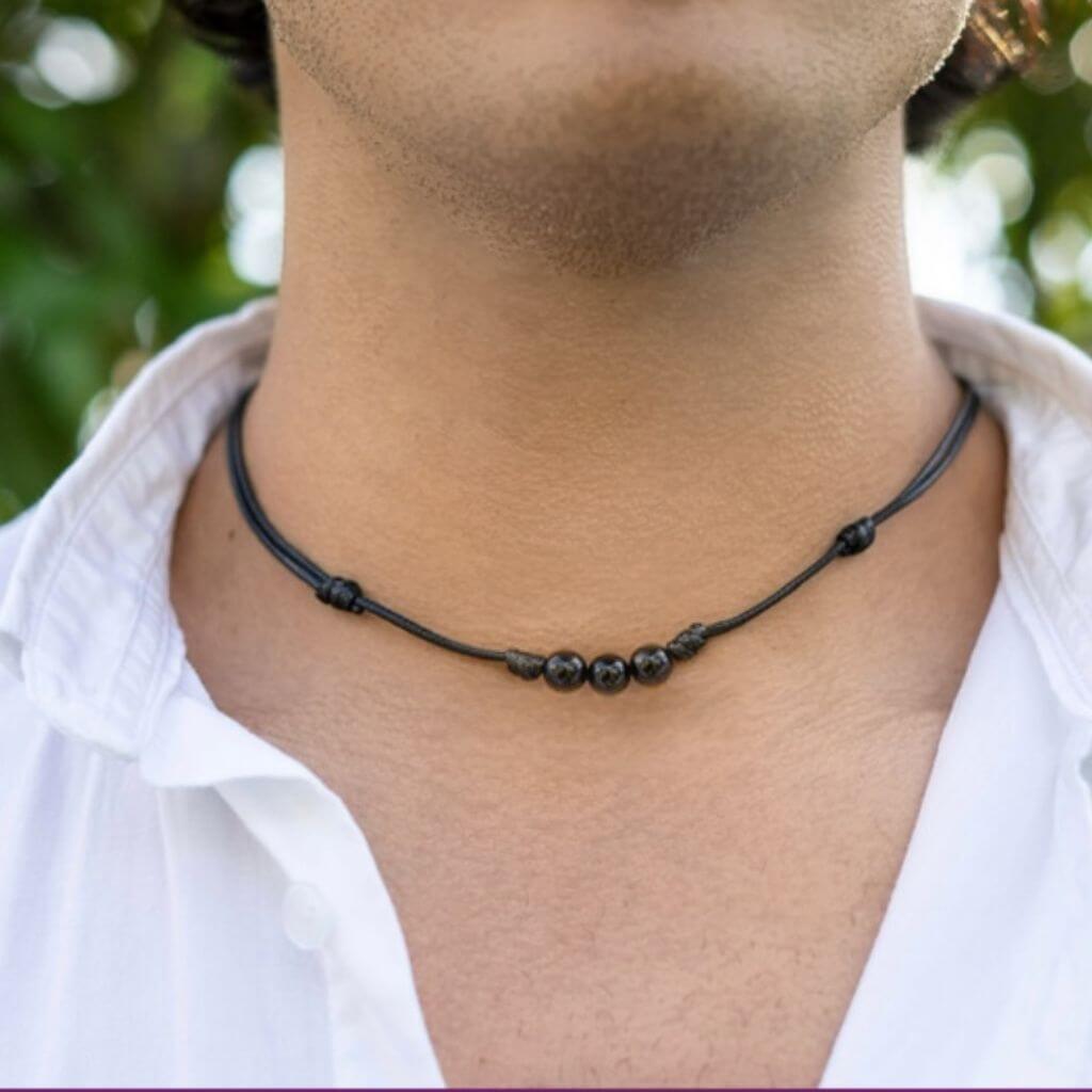 Man adorned with a Black Tourmaline Beaded Choker, highlighting how the dark, protective beads complement his modern and stylish look - Luck Strings