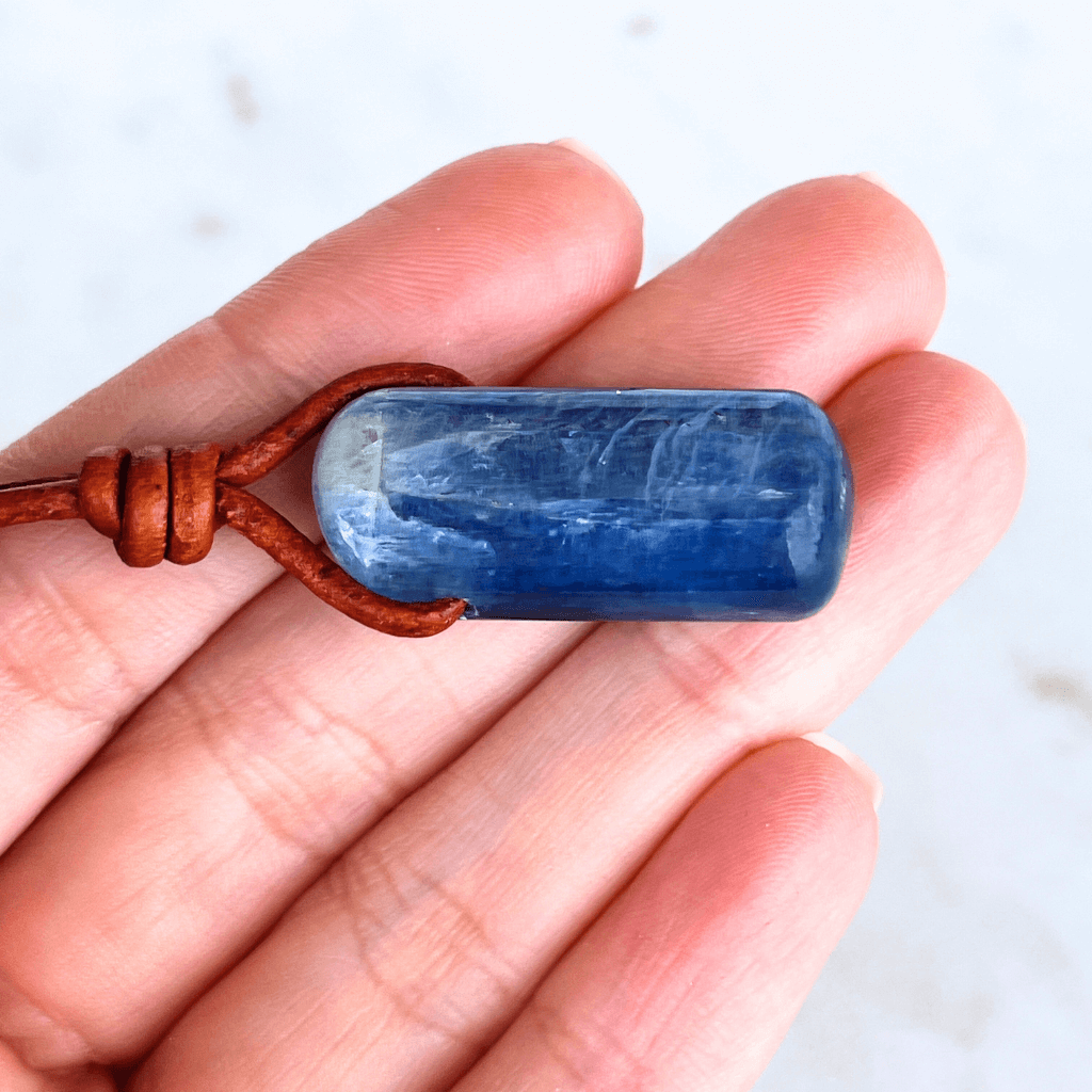 A handcrafted Kyanite pendant with elegant blue hues, symbolizing serenity and sophistication.