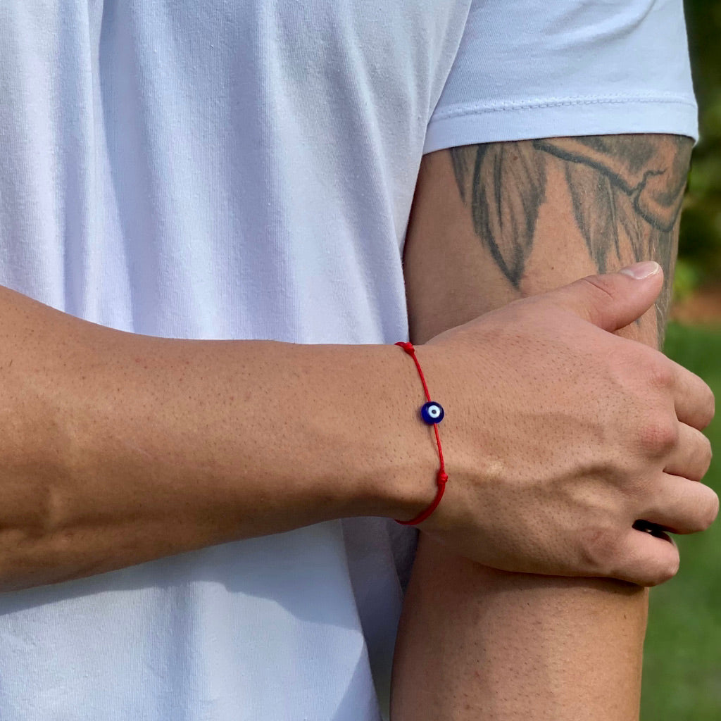 Man wearing a minimalist red cord evil eye bracelet, showcasing a subtle yet stylish protective accessory. - Luck Strings






Man wearing a stylish evil eye bracelet, highlighting its bold and protective charm.






