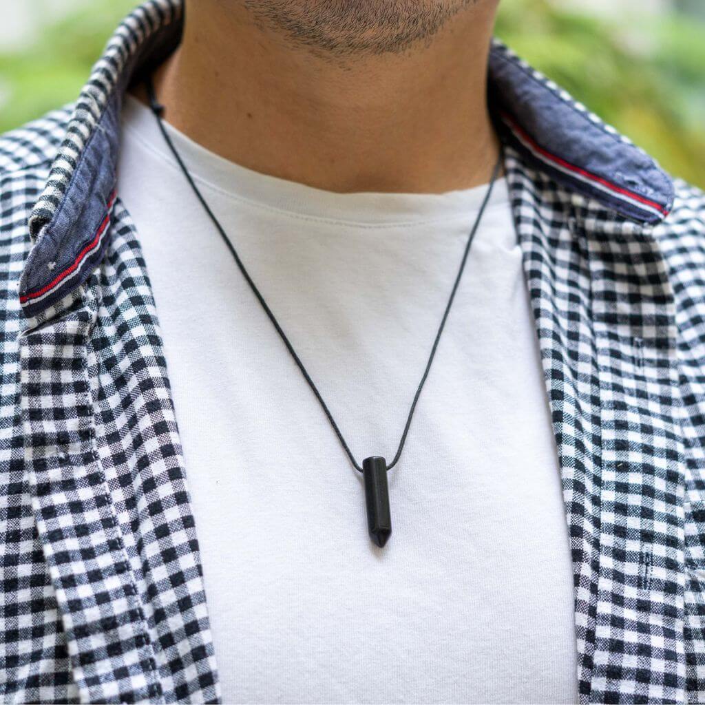 Man stylishly adorned with a Bullet Point Gemstone Necklace, reflecting his personal style and choice of gemstone - Luck Strings