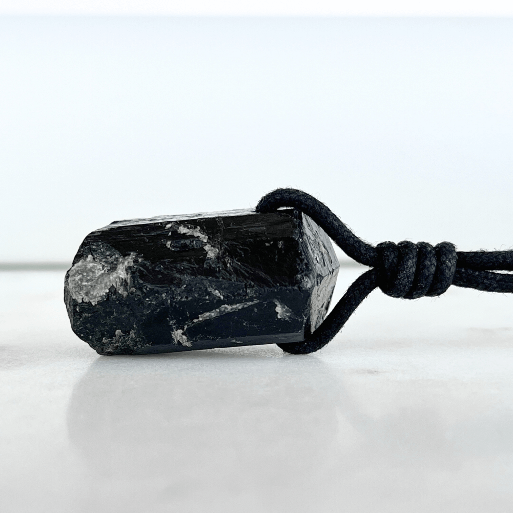 One-of-a-Kind Raw Black Tourmaline Pendant - A unique symbol of protection and individuality by Luck Strings.