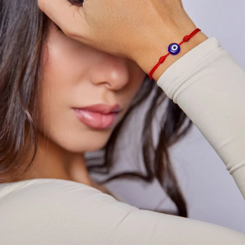 Woman wearing a delicate evil eye bracelet, showcasing its elegant and protective design -Luck Strings