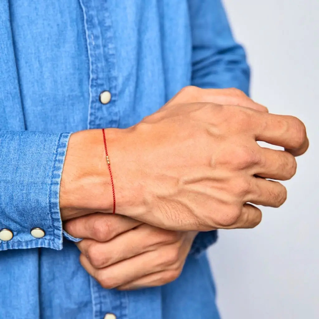 Red silky cord bracelet with three solid gold beads and a secure clasp, showcasing a minimalist and elegant design. - Luck Strings