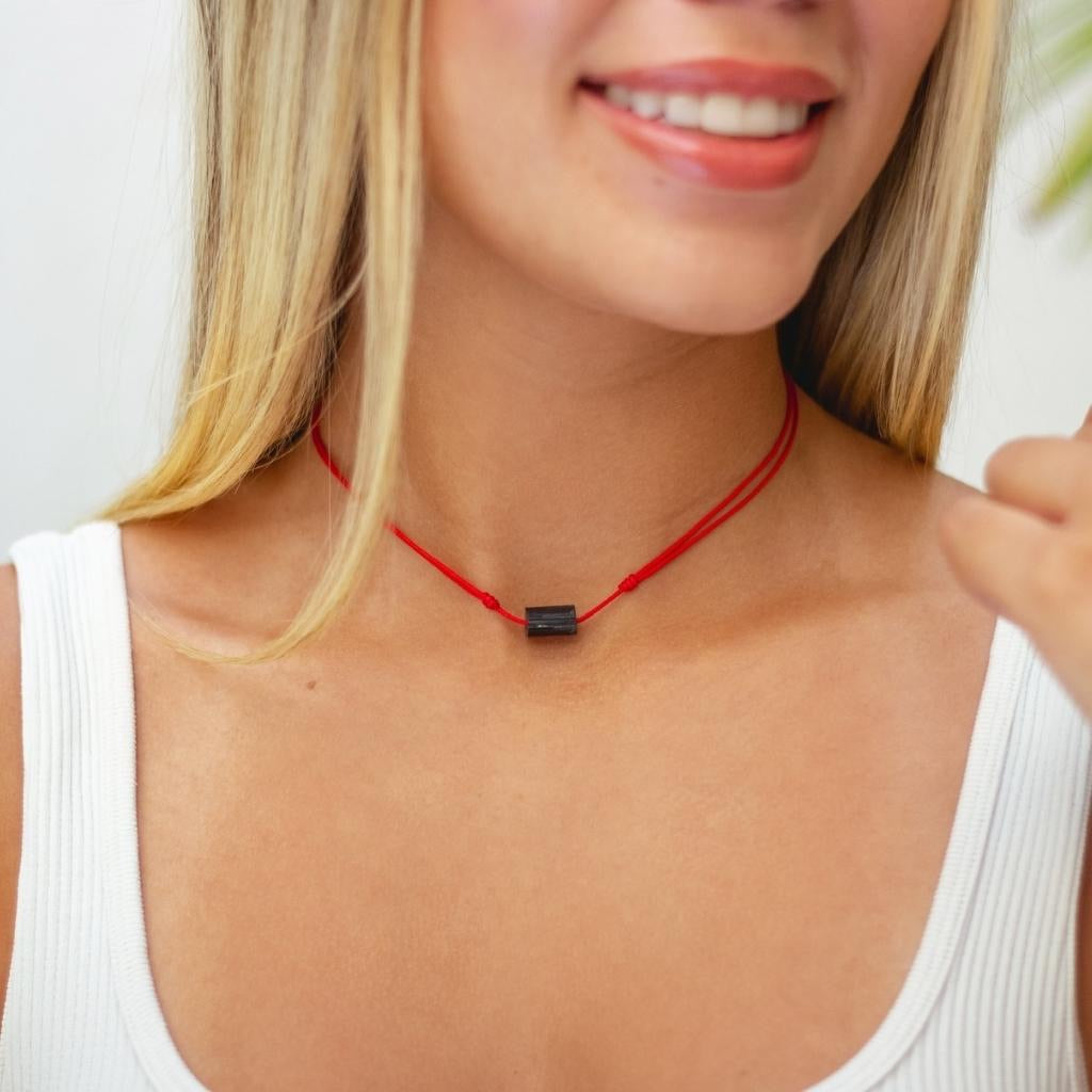 Woman wearing a Black Tourmaline Choker Necklace, radiating elegance and confidence, black tourmaline bead symbolizing protection and luck - Luck Strings