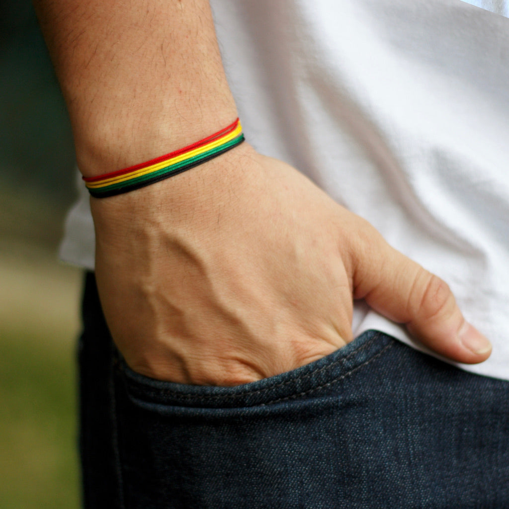 red yellow green black cord bracelets stacked together, adjustable, waterproof, versatile, unisex