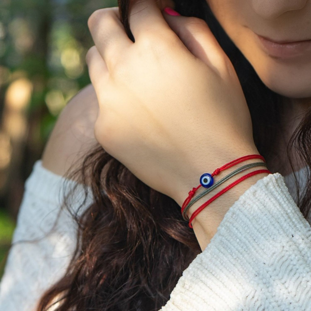 Woman wearing a bracelet from the Red String Protection Duo, signifying harmony and mutual support - Luck Strings