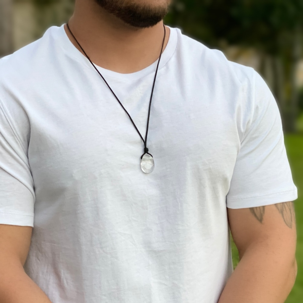 Luck Strings Clear Quartz pendant necklace elegantly displayed by a man in a casual shirt, with the stone prominently featured against his chest