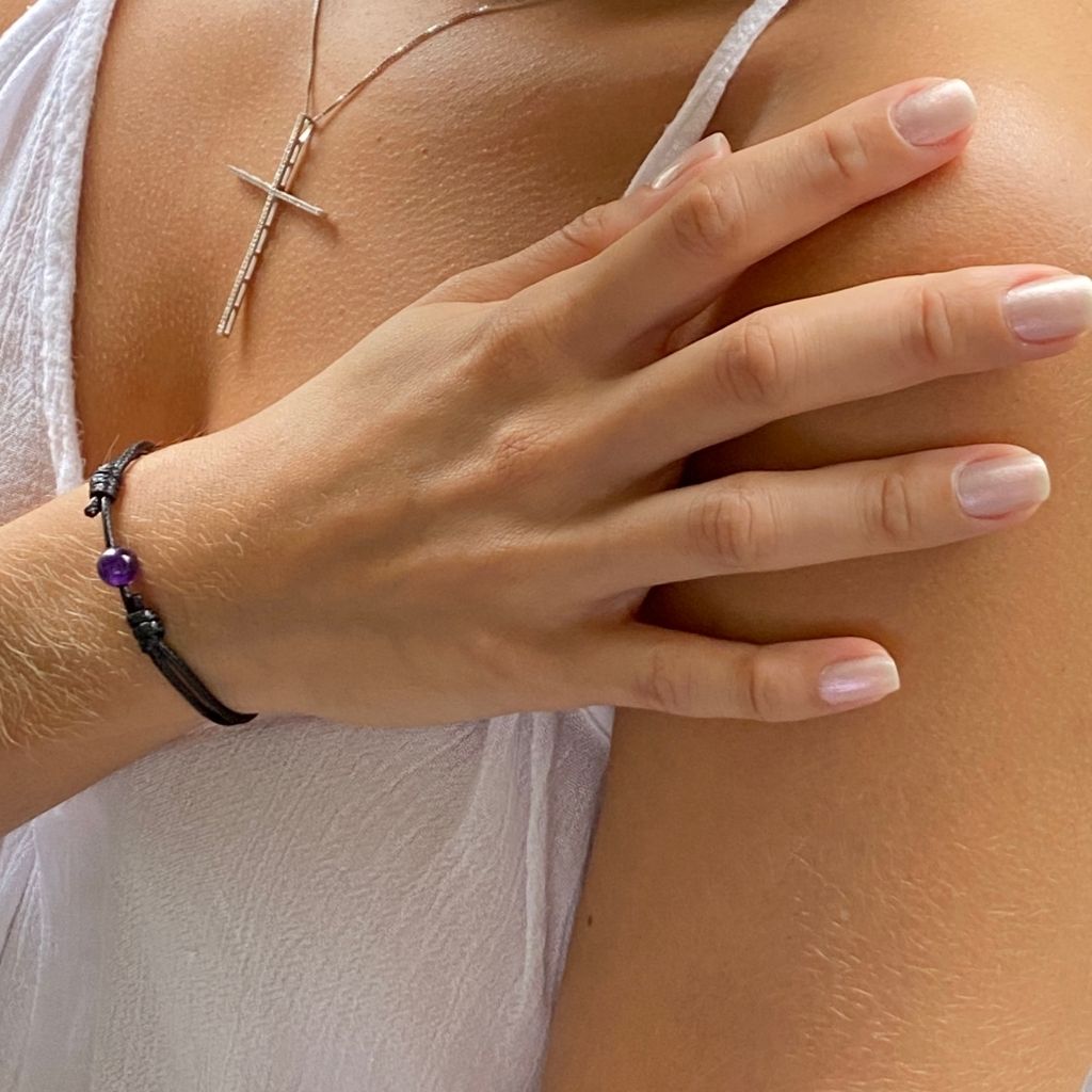 Woman gracefully wearing the Amethyst Beaded Bracelet, reflecting its serene beauty and calming elegance - Luck Strings
